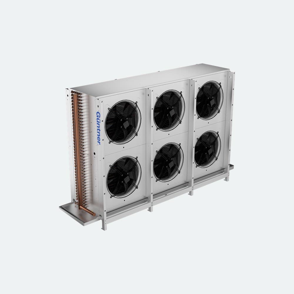 Industrial cooling unit with a tall copper spiral coil on the left and four large fans on silver panels, branded Güntner.