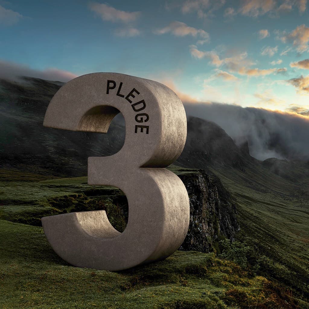 Large stone number 3 with PLEDGE on its arc sits on a grassy hillside, with misty mountains and a sunrise in the background.