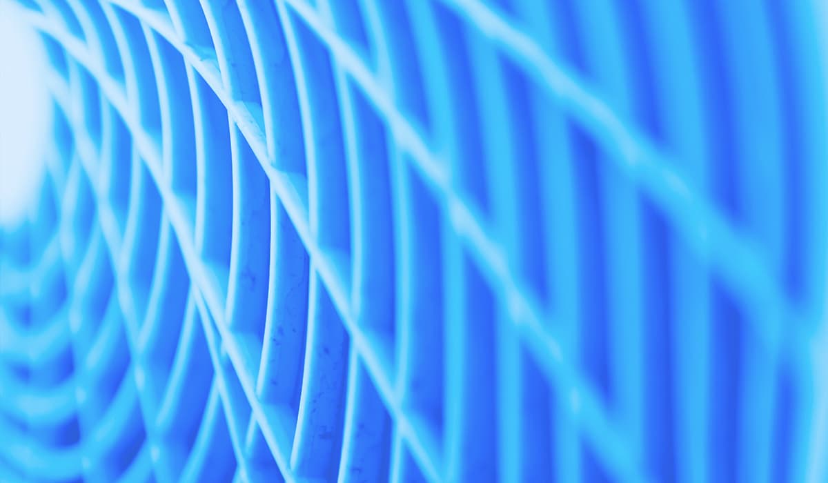 Close-up of blue curved wires forming a repeating lattice pattern, an abstract grid of lines.