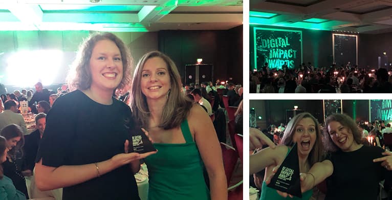 Two people pose with a trophy at an awards event; green stage lighting and a crowded banquet hall with a Digital Impact Awards banner.