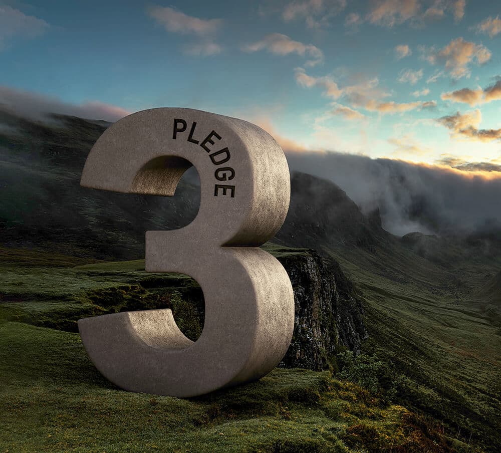 A colossal stone number 3 with the word PLEDGE curved along its top stands in a misty green valley with cliffs and a sunset sky.